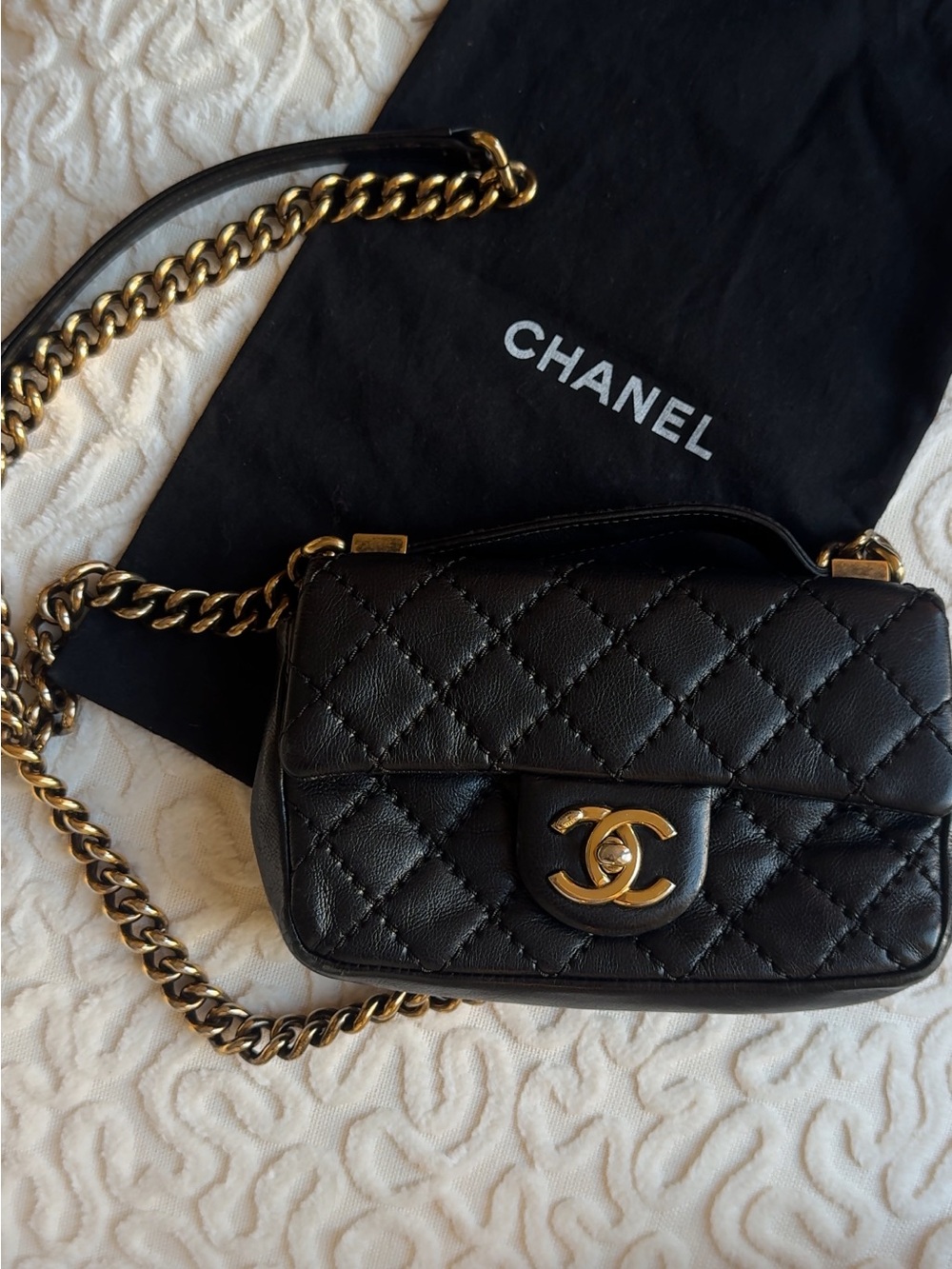 CHANEL Black Quilted Leather Mini Crossbody with Gold Chain